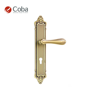 Bronces Coba 360-S Handle Set on Plate in Old Antique Brass Finish, made in Spain, featuring an intricate vintage design.
