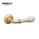 Mandelli 8011 Naxos door handle in polished brass and white calacatta, showcasing exceptional Italian craftsmanship.
