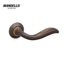 Mandelli 981 Plissé door handle in matt bronze finish, displaying elegant curves and a refined design, fully crafted in Italy.