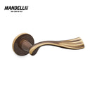 Mandelli 1201 River door handle in bronze, showcasing a fluid, ergonomic design and a luxurious bronze finish, crafted from solid brass in Italy.