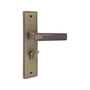 S1245H1779 door handle set on a rectangular backplate in an AB/MAB finish, featuring an angular lever with a faceted dark inlay and a privacy turn knob.