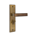 S1245H1779 door handle set on a rectangular backplate in a Double Coffee finish, featuring an angular lever with a faceted inlay and a privacy turn knob.