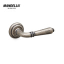 Mandelli 531 Sevilla door handle in Antique Chrome, featuring detailed craftsmanship and a unique finish, crafted in Italy.