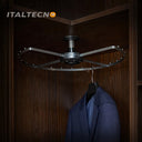 Referencing Top Mounted 360 Degree Rotating Clothes Rack 1.jpg, the grey carousel clothes rack is mounted to the top of a dark wood corner cabinet. Top Mounted 360 Degree Rotating Clothes Rack 2.jpg shows a close-up of the central ceiling mount and the rotating bearing mechanism. Top Mounted 360 Degree Rotating Clothes Rack 3.jpg provides a macro view of the metal spacing pegs distributed along the curved outer frame. Top Mounted 360 Degree Rotating Clothes Rack 4.jpg displays a blue suit jacket hanging fro