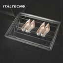 An Italtecno pull-out wire shoe rack with a grey metal frame is extended from a dark wood wardrobe, neatly displaying two pairs of sparkling high heels on its angled wire tiers.