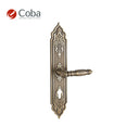 Bronces Coba 350-S Handle Set on Plate in Old Antique Brass Finish, made in Spain, featuring intricate vintage detailing.