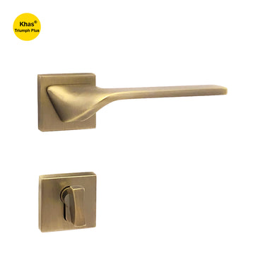 Khas Triumph Plus A14-1562 door handle set with rosette in matte antique brass finish, featuring a sleek angular design and refined modern look.