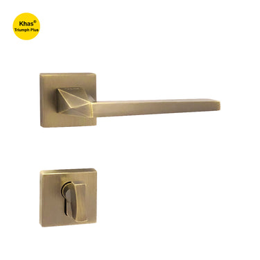 Khas Triumph Plus A14-1593 door handle set with rosette in matt antique brass finish, featuring a geometric angular design and modern appeal.