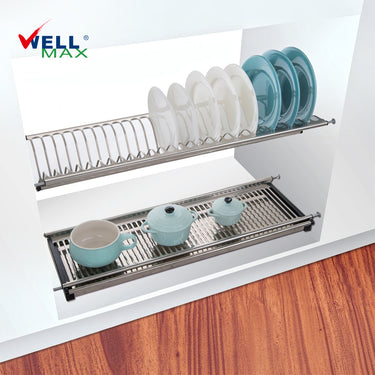Referencing Adjustable dish rack SJ304.jpg, a polished stainless steel two-tier dish rack is installed inside a white wall cabinet, with the top slotted layer holding plates and the bottom flat layer holding light blue bowls and cups.