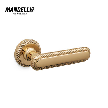 Mandelli 1641 Cocò door handle in satin and polished brass finish, crafted in Italy, featuring elegant ridging and solid construction.