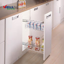Wellmax PTJ003G side-mounted pull-out drawer basket organizer in a chrome finish, installed in a white base cabinet and fully stocked with milk cartons and drink bottles.