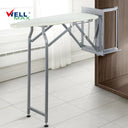 Referencing Folding Ironing Board HZ040C 3.jpg, the Wellmax folding ironing board is deployed from a dark wood wardrobe, showing its sturdy grey iron frame and supporting leg. Folding Ironing Board HZ040C 2.jpg displays the underside of the ironing board when folded up, highlighting the high-density through-hole network and structural reinforcement. Folding Ironing Board HZ040C 1.jpg shows a side profile of the folded ironing board, illustrating its compact, space-saving vertical position. Folding Ironing B