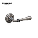 Mandelli 1421 Gou door handle in antique chrome finish, showcasing intricate craftsmanship and a timeless design, made in Italy.