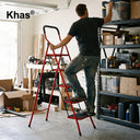 Referencing House Hold Steel Ladder With Square Handle 1.jpg, an open 5-step steel ladder featuring a bright red frame and black steps stands against a white background. House Hold Steel Ladder With Square Handle 2.jpg displays close-up callouts highlighting the ladder's padded square handrail, plastic non-slip pedal, non-slip feet, pedal fixed hook, and cross-braced solid structure. House Hold Steel Ladder With Square Handle.jpg shows a man safely using the red 5-step ladder in a garage to reach the top sh