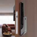 Italtecno KX2 push-pull automatic smart door lock in black, featuring a sleek glass texture panel, digital keypad, and integrated doorbell.