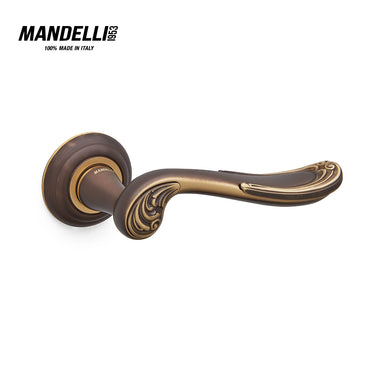 Mandelli 1021 Lord door handle in matt bronze finish, highlighting intricate craftsmanship and solid brass material, manufactured in Italy.
