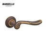 Mandelli 1021 Lord door handle in matt bronze finish, highlighting intricate craftsmanship and solid brass material, manufactured in Italy.