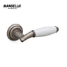Mandelli 1201 Melody door handle in antique chrome and ceramic, showcasing traditional Italian craftsmanship and unique style.