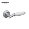 Mandelli 1201 Melody door handle in polished chrome and white ceramic, illustrating the union of modern design and traditional Italian craftsmanship.