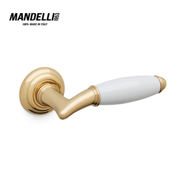 Mandelli 1201 Melody door handle in polished brass and white ceramic, symbolizing the harmony of Italian design and craftsmanship.