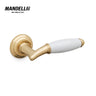Mandelli 1201 Melody door handle in polished brass and white ceramic, symbolizing the harmony of Italian design and craftsmanship.