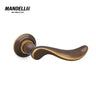 Mandelli 1211 Norma door handle in polished bronze, highlighting smooth lines and luxury craftsmanship.