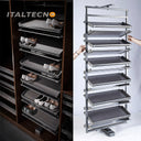Referencing REVOLVING SHOE RACK .jpg, a split image shows the grey multi-layer rotating shoe rack installed in a dark wardrobe on the left, and being manually rotated by hands on a white background on the right. REVOLVING SHOE RACK 1.jpg displays the rack angled outward in a dark wood closet, showing high heels and flats stored on its staggered leather-lined shelves. REVOLVING SHOE RACK 2.jpg gives a slim side-profile view of the revolving rack inside the wardrobe. REVOLVING SHOE RACK 3.jpg provides a close
