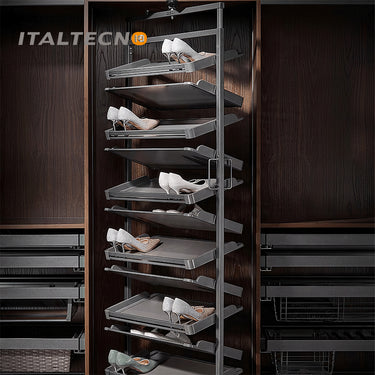 Referencing REVOLVING SHOE RACK .jpg, a split image shows the grey multi-layer rotating shoe rack installed in a dark wardrobe on the left, and being manually rotated by hands on a white background on the right. REVOLVING SHOE RACK 1.jpg displays the rack angled outward in a dark wood closet, showing high heels and flats stored on its staggered leather-lined shelves. REVOLVING SHOE RACK 2.jpg gives a slim side-profile view of the revolving rack inside the wardrobe. REVOLVING SHOE RACK 3.jpg provides a close
