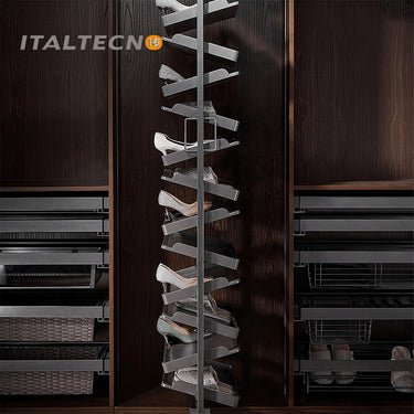 Referencing REVOLVING SHOE RACK .jpg, a split image shows the grey multi-layer rotating shoe rack installed in a dark wardrobe on the left, and being manually rotated by hands on a white background on the right. REVOLVING SHOE RACK 1.jpg displays the rack angled outward in a dark wood closet, showing high heels and flats stored on its staggered leather-lined shelves. REVOLVING SHOE RACK 2.jpg gives a slim side-profile view of the revolving rack inside the wardrobe. REVOLVING SHOE RACK 3.jpg provides a close