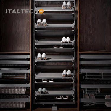 Referencing REVOLVING SHOE RACK .jpg, a split image shows the grey multi-layer rotating shoe rack installed in a dark wardrobe on the left, and being manually rotated by hands on a white background on the right. REVOLVING SHOE RACK 1.jpg displays the rack angled outward in a dark wood closet, showing high heels and flats stored on its staggered leather-lined shelves. REVOLVING SHOE RACK 2.jpg gives a slim side-profile view of the revolving rack inside the wardrobe. REVOLVING SHOE RACK 3.jpg provides a close
