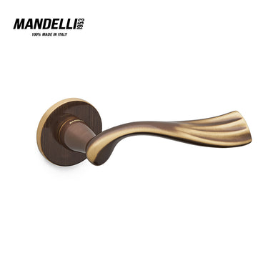 Mandelli 1201 River door handle in bronze, showcasing a fluid, ergonomic design and a luxurious bronze finish, crafted from solid brass in Italy.