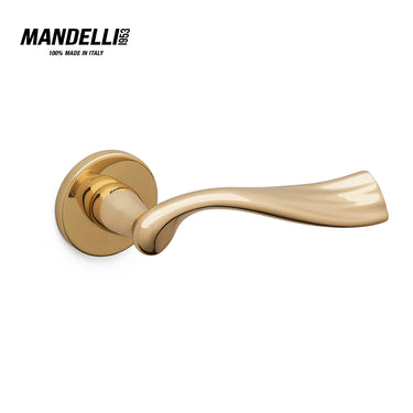 Mandelli 1201 River door handle in polished brass, showcasing a sleek, curving design with a shiny finish, crafted from solid brass in Italy.