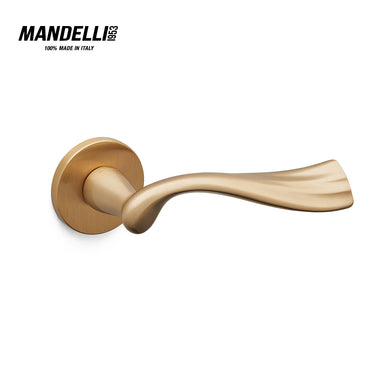 Mandelli 1201 River door handle in satin brass, featuring a unique, flowing design and a soft metallic finish, crafted in Italy.