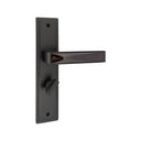 S1245H1779 door handle set on a rectangular backplate in a Dull Black/Shine Black finish, featuring an angular lever with a faceted glossy inlay and a privacy turn knob.