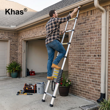 Referencing Telescopic Ladder 1.jpg, a man climbs the extended aluminum telescopic ladder to reach the upper trim of a brick house. Telescopic Ladder 2.jpg displays detailed close-up callouts highlighting the ladder's securing strap, safety catch mechanism, grip handle, and strengthening footboard. Telescopic Ladder.jpg shows the ladder partially extended, standing upright against a plain white background.