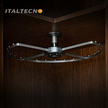 Referencing Top Mounted 360 Degree Rotating Clothes Rack 1.jpg, the grey carousel clothes rack is mounted to the top of a dark wood corner cabinet. Top Mounted 360 Degree Rotating Clothes Rack 2.jpg shows a close-up of the central ceiling mount and the rotating bearing mechanism. Top Mounted 360 Degree Rotating Clothes Rack 3.jpg provides a macro view of the metal spacing pegs distributed along the curved outer frame. Top Mounted 360 Degree Rotating Clothes Rack 4.jpg displays a blue suit jacket hanging fro
