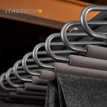 Referencing V Shape pants rack 1.jpg, a grey top-mounted L-shape pants rack is pulled out in a dark wardrobe, holding a pair of dark grey trousers. V Shape pants rack 2.jpg shows a close-up of the cold-rolled steel hooks and the soft cylinder flocking sponge tubes. V Shape pants rack 3.jpg provides a macro view of the textured non-slip flocking sponge tubes with metal end caps. V Shape pants rack 4.jpg illustrates the internal damping buffer guide rail mechanism for smooth sliding. V Shape pants rack 5.jpg 